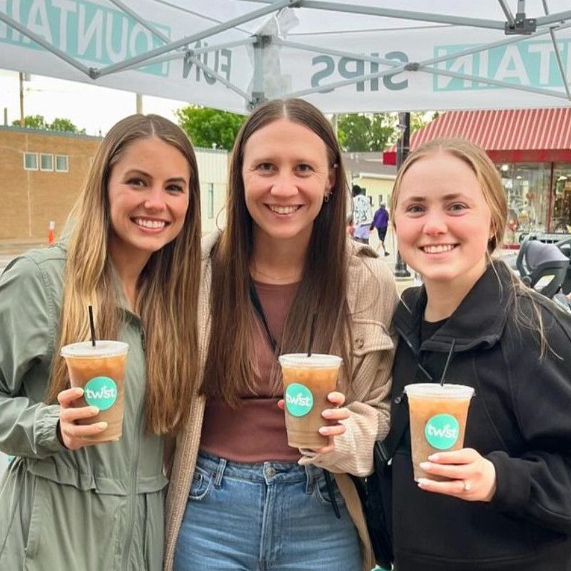 3 people smiling and holding their Twist drinks